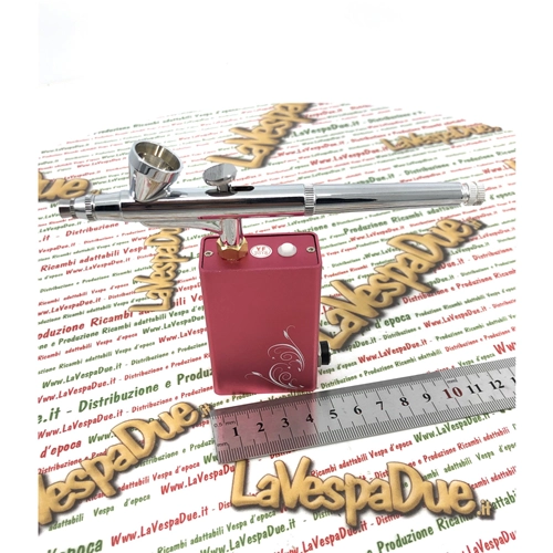 Portable battery-powered airbrush kit with mini compressor, battery charger and USB cable for precise and flawless bodywork touch-ups.