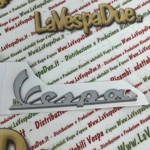 Beschriftungsaufkleber aus verchromtem Kunstharz für die Frontplatte von VESPA PX 125 und 150 ab Baujahr 2011 (RO 656219 577082, Länge 98 mm)